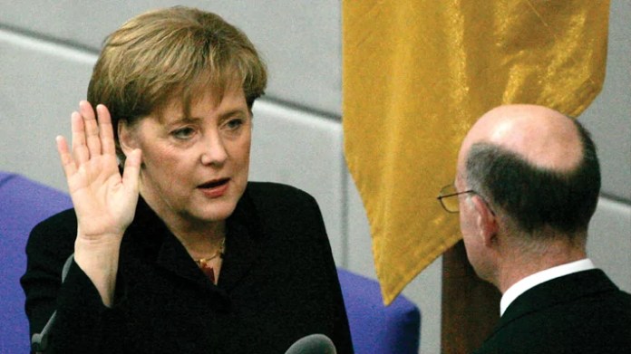Newly appointed German chancellor Angela Merkel takes the oath of office in Berlin on Nov. 22, 2005. (Jockel Finck/AP)