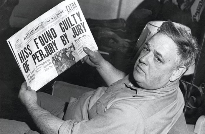 Whittaker Chambers reads the headline documenting the conviction of Alger Hiss.