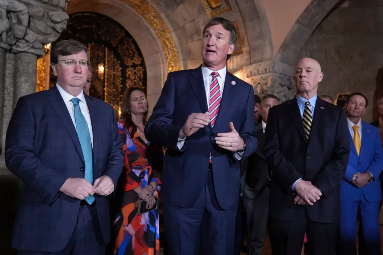 Gov. Glenn Youngkin (R-VA), center, speaks as Gov. Tate Reeves (R-MS), left, and Gov. Greg Gianforte (R-MT) listen during a meeting with Republican governors at Mar-a-Lago, Thursday, Jan. 9, 2025, in Palm Beach, Florida.
