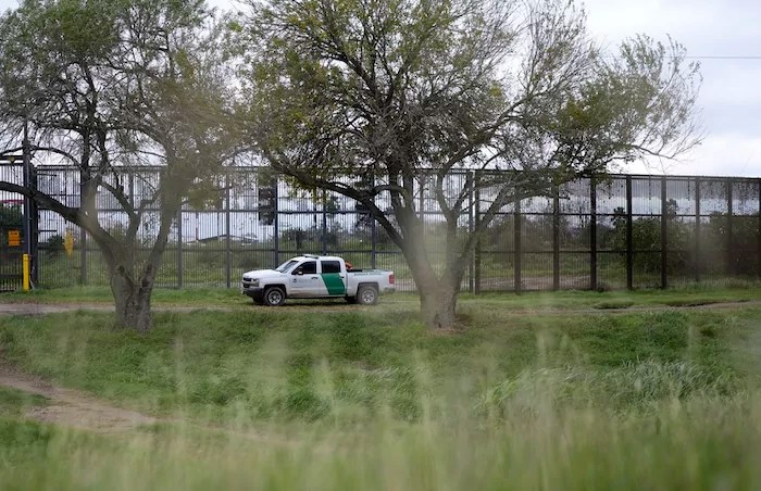 A Border Patrol agent patrols along a stretch of boarder wall, Tuesday, Jan. 21, 2025, in Brownsville, Texas. (AP Photo/Eric Gay)