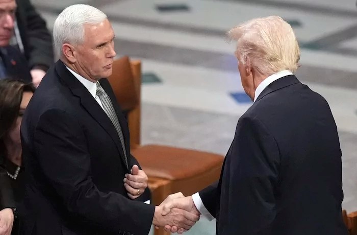 ald Trump shakes hands with former Vice President Mike Pence before the state funeral for former President Jimmy Carter at Washington National Cathedral in Washington, Thursday, Jan. 9, 2025.