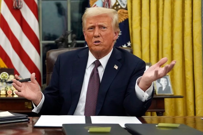 President Donald Trump talks to reporters as he signs executive orders on Monday, Jan. 20, 2025, in the Oval Office of the White House in Washington. (AP Photo/Evan Vucci)
