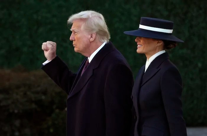 President Donald Trump gestures as he walks with first lady Melania Trump after a church service at St. John's Episcopal Church across from the White House on his inauguration day in Washington, Monday, Jan. 20, 2025.