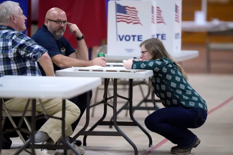 Derry, N.H., town councillors Jack Web, left, David Granese, center, and Erin Spencer, right, speak after voting concluded at a polling place on the campus of Pinkerton Academy,