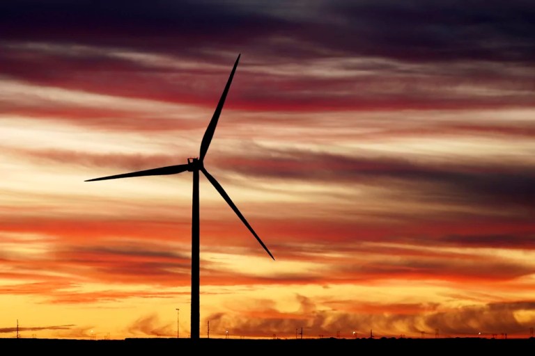 The sun rises behind a windmill before President Joe Biden's visit to CS Wind, the world's largest facility for wind tower manufacturing, Wednesday, Nov. 29, 2023, in Pueblo, Colorado.