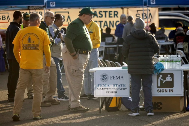 People from various relief agencies guide people impacted by the wildfires at a FEMA Disaster Recovery Center at Pasadena City College Thursday, Jan. 16, 2025, in Pasadena, Calif.