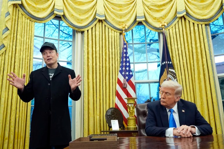 President Donald Trump listens as Elon Musk speaks in the Oval Office at the White House, Tuesday, Feb. 11, 2025, in Washington. (AP Photo/Alex Brandon)