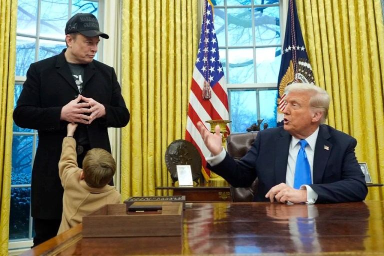 President Donald Trump speaks as Elon Musk, joined by his son, X Æ A-Xii, listens in the Oval Office at the White House, Tuesday, Feb. 11, 2025, in Washington.