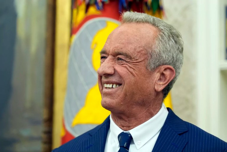 Robert F. Kennedy Jr., listens as President Donald Trump speaks before he is sworn in as Health and Human Services Secretary in the Oval Office at the White House, Thursday, Feb. 13, 2025, in Washington.