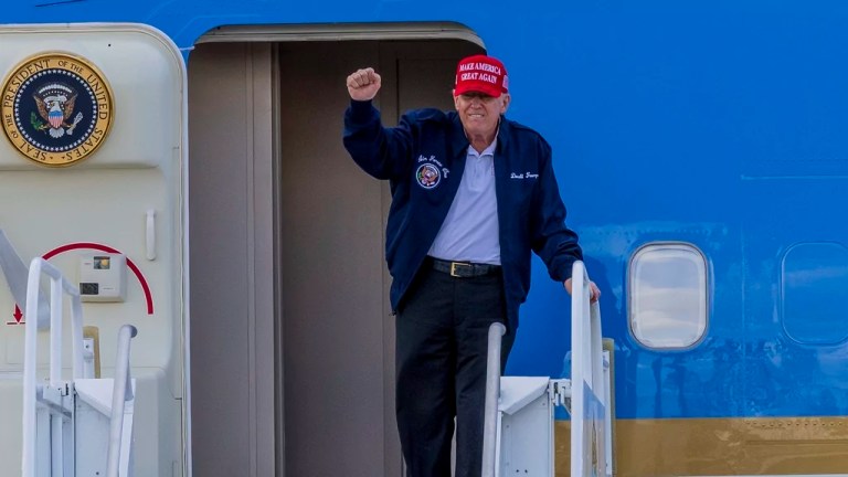 President Donald Trump reacts as he arrives on Air Force One at Miami International Airport, Wednesday, Feb. 19, 2025. (Pedro Portal/Miami Herald via AP)