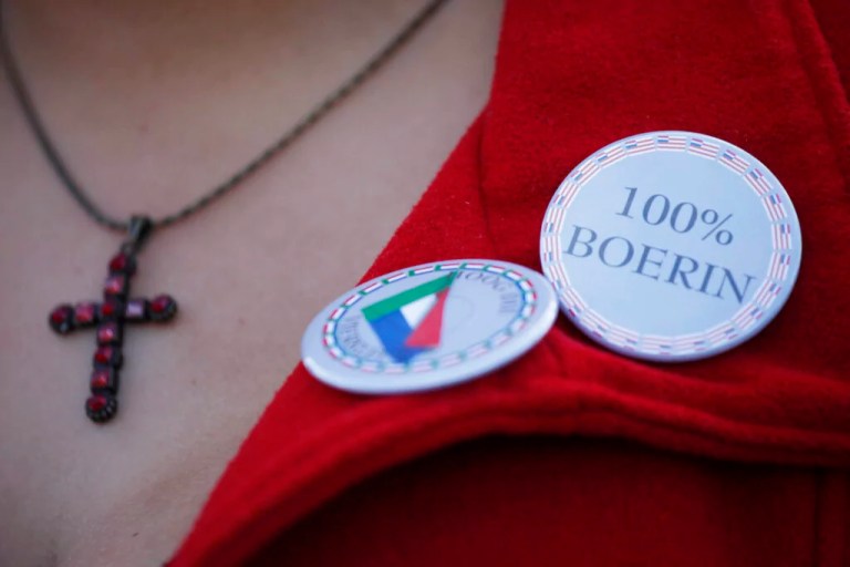 A Boer woman with a pin saying 