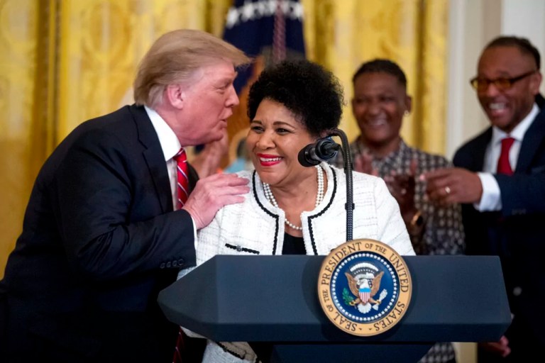 President Donald Trump speaks to Alice Marie Johnson, an inmate whose life sentence was commuted thanks in part to the efforts of Kim Kardashian West, at the 2019 Prison Reform Summit and First Step Act Celebration in the East Room of the White House.