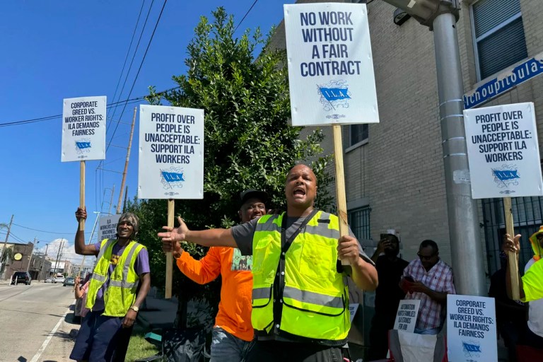 International Longshoremen's Association dockworker Oliver Bailey appeals to passerby for honks in support of the dockworker strike while picketing near the Port of New Orleans in Louisiana, Tuesday, Oct. 1, 2024.