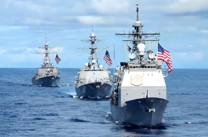 Three Navy Destroyers at sea with their American flags raised. (MC1 Denny Cantrell/U.S. Navy)
