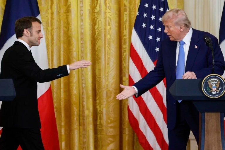 President Donald Trump, right, and France's President Emmanuel Macron reach to shake hands during a joint press conference in the East Room of the White House in Washington, Monday, Feb. 24, 2025.