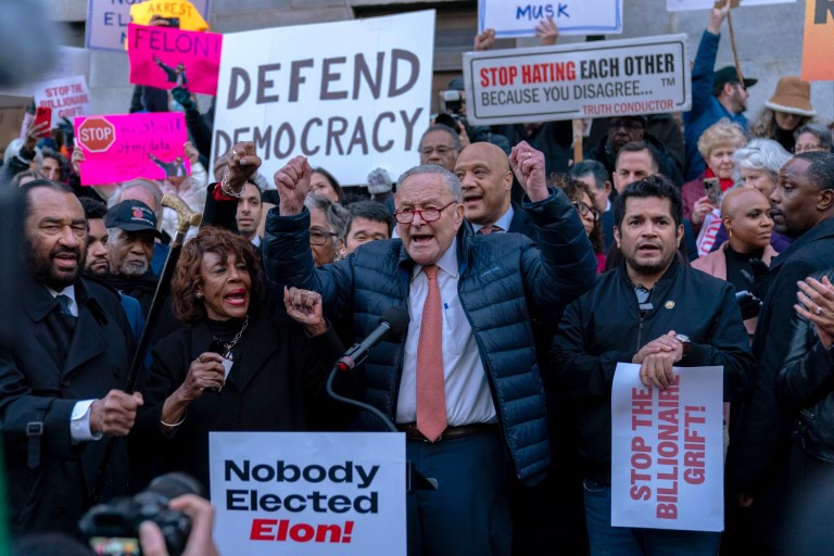 Senate Minority Leader Chuck Schumer (D-NY), accompanied by other members of congress, including Rep. Maxine Waters (D-CA), left, speaks during a rally against Elon Musk outside the Treasury Department in Washington, Tuesday, Feb. 4, 2025.