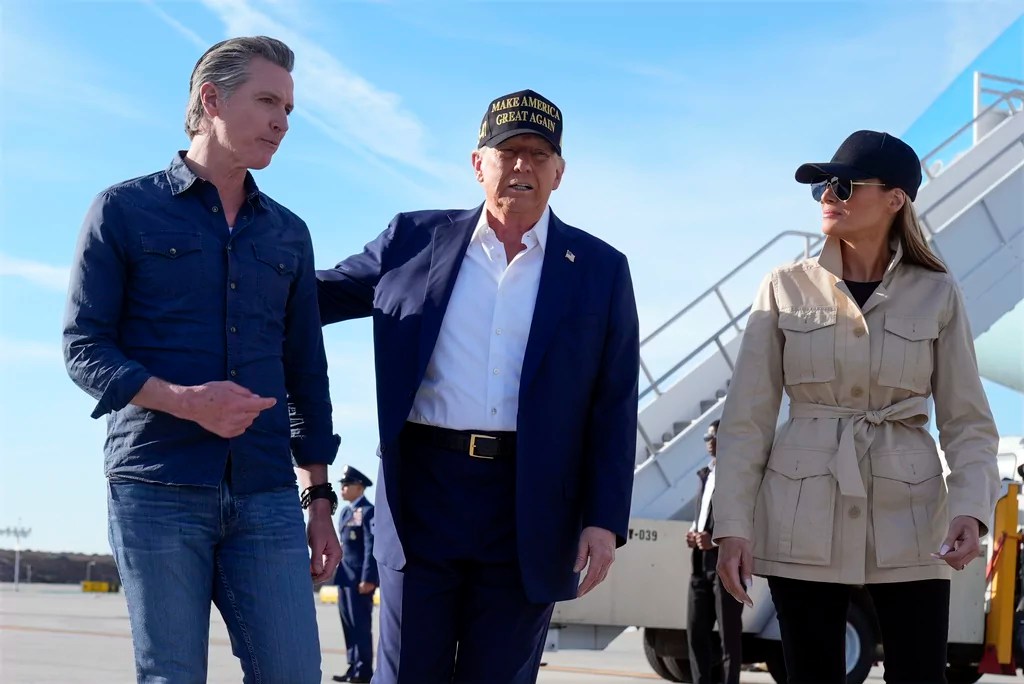 President Donald Trump and first lady Melania Trump walk with California Gov. Gavin Newsom after arriving on Air Force One at Los Angeles International Airport in Los Angeles, Friday, Jan. 24, 2025. (AP Photo/Mark Schiefelbein)