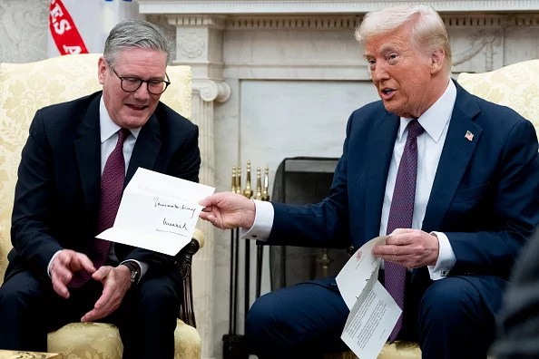 US President Donald Trump, right, holds a letter from King Charles III, presented during a meeting with Keir Starmer, UK prime minister, in the Oval Office of the White House in Washington, DC, US, on Thursday, Feb. 27, 2025. The trip is seen as an opportunity for Starmer to prove himself as a global leader, defend democratic values, and make Britain stronger at home, while also navigating the complexities of dealing with Trump.