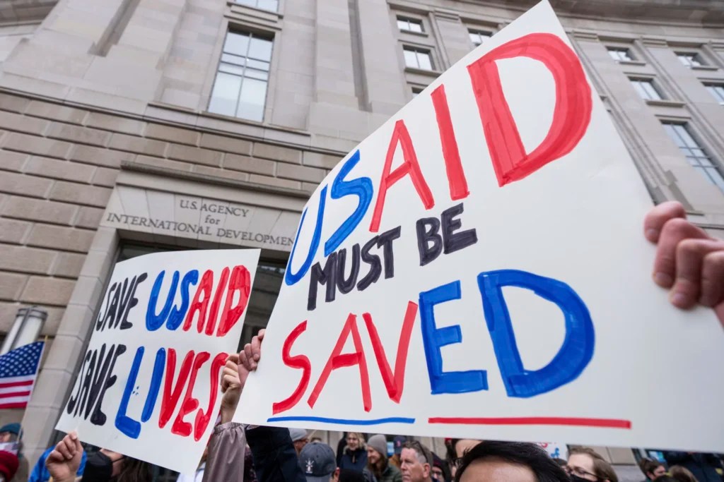 Employees and supporters protest outside the headquarters of the United States Agency for International Development, Monday, Feb. 3, 2025, after Elon Musk posted on social media that he and President Donald Trump would shut down the agency.