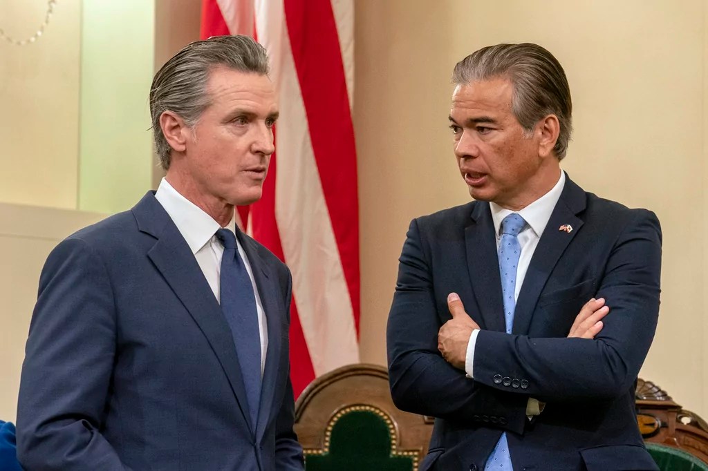 Gov. Gavin Newsom (D-CA), left, talks with California Attorney General Rob Bonta during the Assembly's Organizational Session in Sacramento, Monday, Dec. 2, 2024.