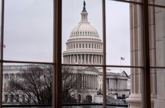 The Capitol is seen framed through a window in the Cannon House Office Building on Capitol Hill.