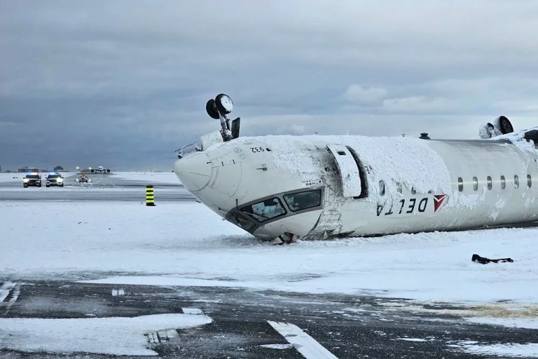 CORRECTS SOURCE TO TRANSPORTATION SAFETY BOARD OF CANADA INSTEAD OF NATIONAL TRANSPORTATION SAFETY BOARD - In this image provided by the Transportation Safety Board of Canada, the wreckage of a Delta Air Lines jet rests upside down, Tuesday, Feb. 18, 2025, after it burst into flames and flipped upside down as it tried to land on Feb. 17, at Toronto Pearson International Airport in Mississauga, Ontario.