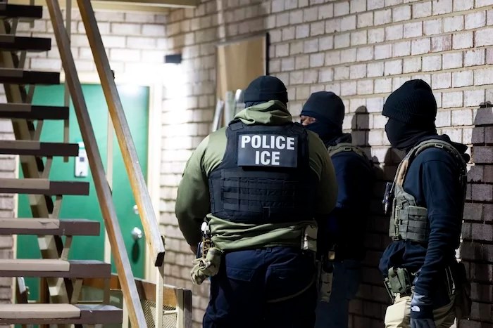 Immigration and Customs Enforcement officers wait to detain a person, Monday, Jan. 27, 2025, in Silver Spring, Maryland.