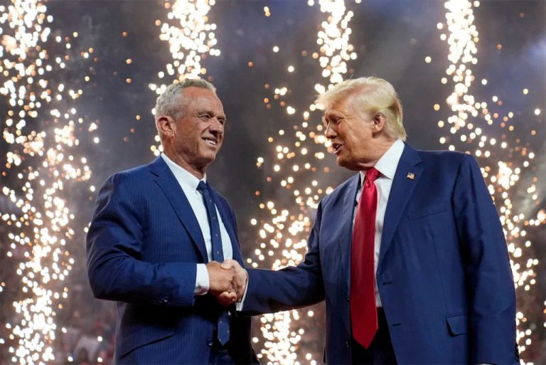 Republican presidential nominee former President Donald Trump shakes hands with Independent presidential candidate Robert F. Kennedy Jr. at a campaign rally at the Desert Diamond Arena, Friday, Aug. 23, 2024, in Glendale, Ariz.