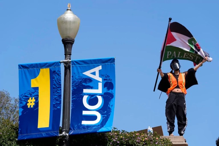 Demonstrators wave flags on the UCLA campus, after nighttime clashes between Pro-Israel and Pro-Palestinian groups, May 1, 2024, in Los Angeles. If the University of California, one of the largest public university systems in the country, were to agree to divestment calls from students protesting the Israel-Hamas war, the system would lose $32 billion of its overall $175 billion in assets, officials said on Tuesday, May 15, 2024.