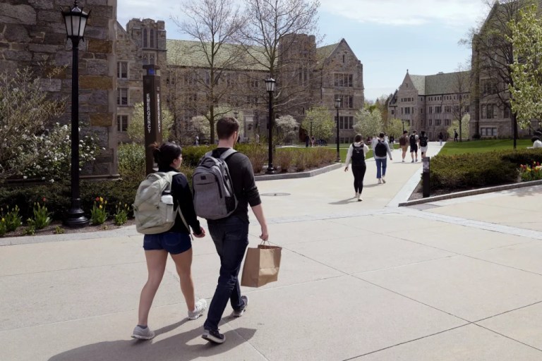 Students walk on the campus of Boston College.