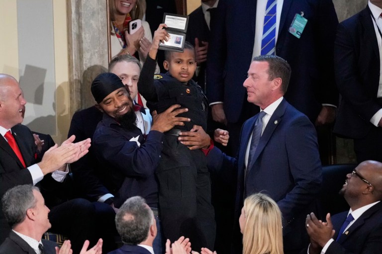 DJ Daniel holds an honorary Secret Service special agent ID presented to him by Secret Service Director Sean Curran, right, as President Donald Trump addresses a joint session of Congress at the Capitol in Washington, Tuesday, March 4, 2025.