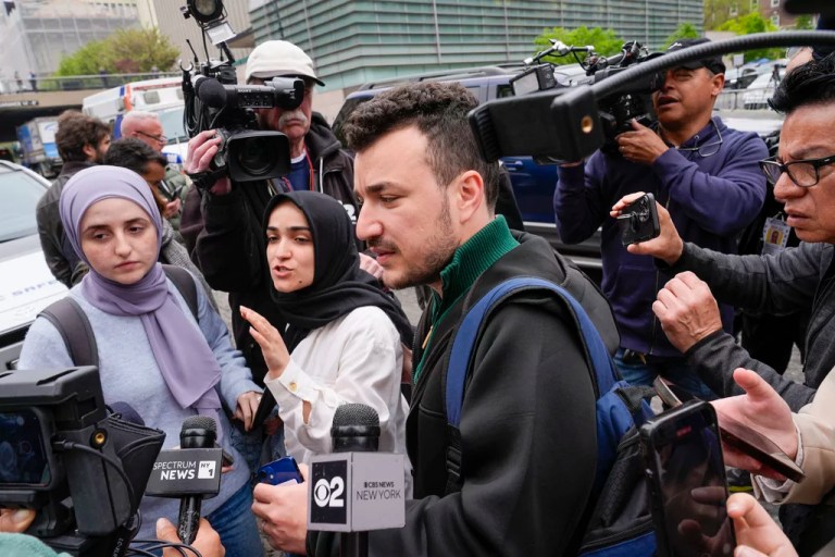 FILE - Members of the Columbia University Apartheid Divest group, including Sueda Polat, second from left, and Mahmoud Khalil, center, are surrounded by members of the media outside the Columbia University campus, Tuesday, April 30, 2024, in New York.