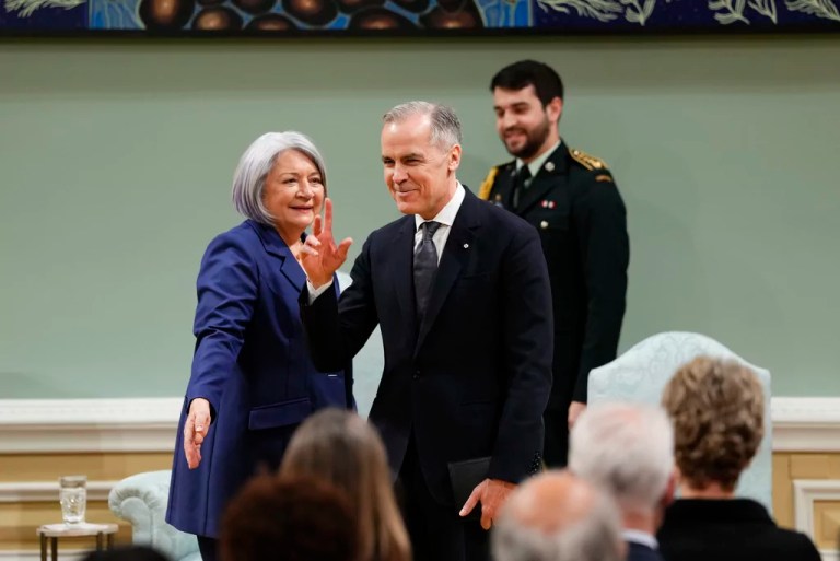 Prime Minister Mark Carney waves after being sworn in as Governor-General Mary Simon looks on at Rideau Hall in Ottawa, Friday, March 14, 2025.