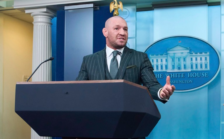 White House press secretary Karoline Leavitt listens as UFC fighter Conor McGregor speaks with reporters in the briefing room of the White House, Monday, March 17, 2025, in Washington.