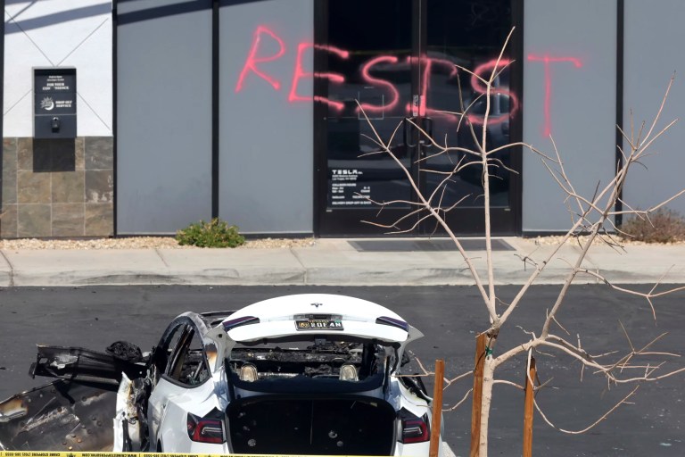 A burned Tesla vehicle is shown at a Tesla collision center, Tuesday, March 18, 2025, in Las Vegas.