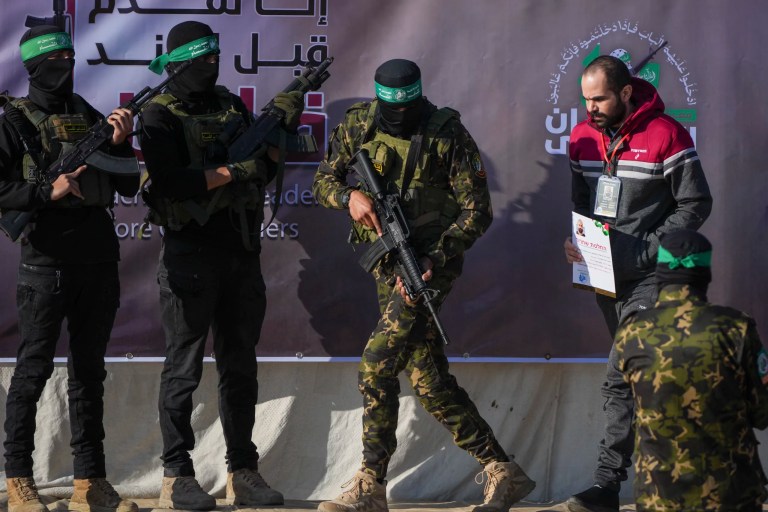 Israeli Yarden Bibas, 34, who has been held hostage by Hamas in Gaza since Oct. 7, 2023, is escorted by Hamas fighters before being handed over to the Red Cross in Khan Younis, southern Gaza Strip, Saturday Feb. 1, 2025.
