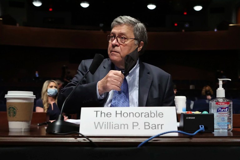 Attorney General William Barr takes off his face mask before testifying during House Judiciary Committee hearing on the oversight of the Department of Justice on Capitol Hill, Tuesday, July 28, 2020 in Washington.