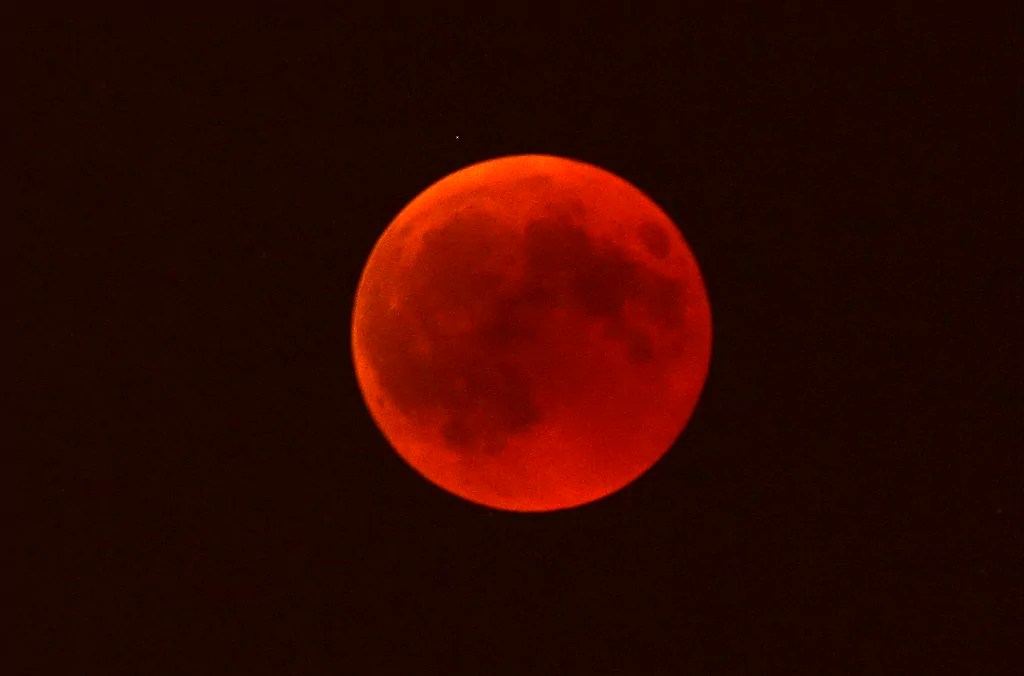 A blood moon rises over Marseille, southern France, Friday, July 27, 2018.