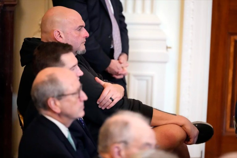 Sen. John Fetterman, D-Pa., listens as President Donald Trump speaks before signing the Laken Riley Act in the East Room of the White House, Wednesday, Jan. 29, 2025, in Washington.