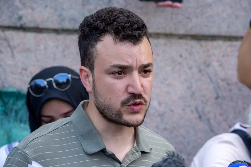 Members of the Columbia University Apartheid Divest group, including Sueda Polat, second from left, and Mahmoud Khalil, center, are surrounded by members of the media outside the Columbia University campus, Tuesday, April 30, 2024, in New York.