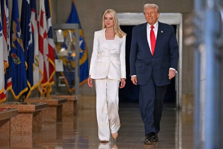 President Donald Trump arrives with Attorney General Pam Bondi to speak at the Justice Department in Washington, Friday, March 14, 2025.