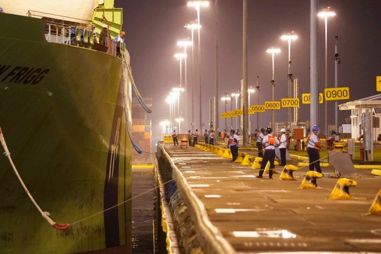 Workers dock a cargo ship at the Panama Canal's Cocoli locks in Panama City, Friday, Feb. 21, 2025.