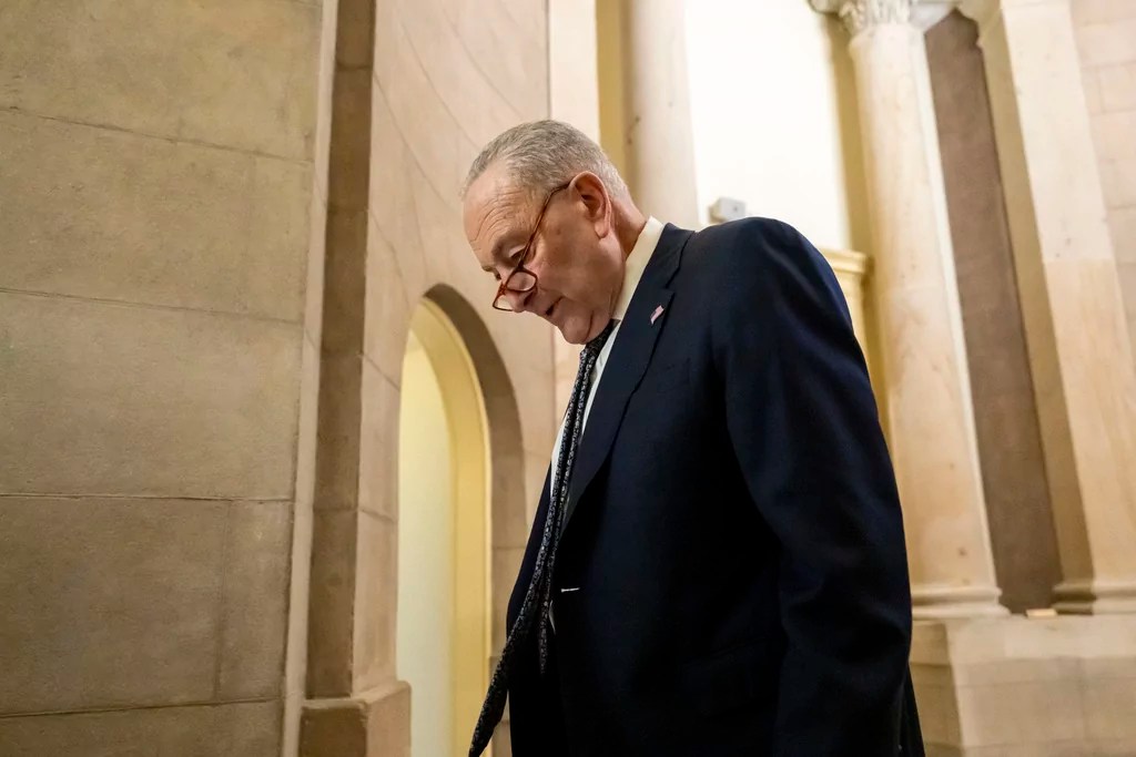 Senate Democratic Leader Chuck Schumer walks near the Senate chamber, as the Senate works to avert a partial government shutdown ahead of the midnight deadline, at the Capitol in Washington, Friday, March 14, 2025. (AP Photo/Ben Curtis)
