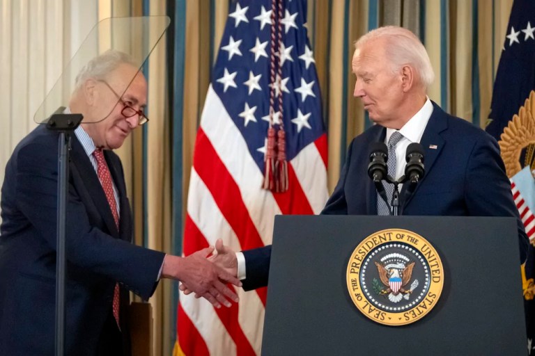 President Joe Biden shakes hands with Senate Majority Leader Chuck Schumer of N.Y., left, during an event to mark his administration's efforts to confirm federal judges during his term in the State Dining Room at the White House, Thursday, Jan. 2, 2025, in Washington.