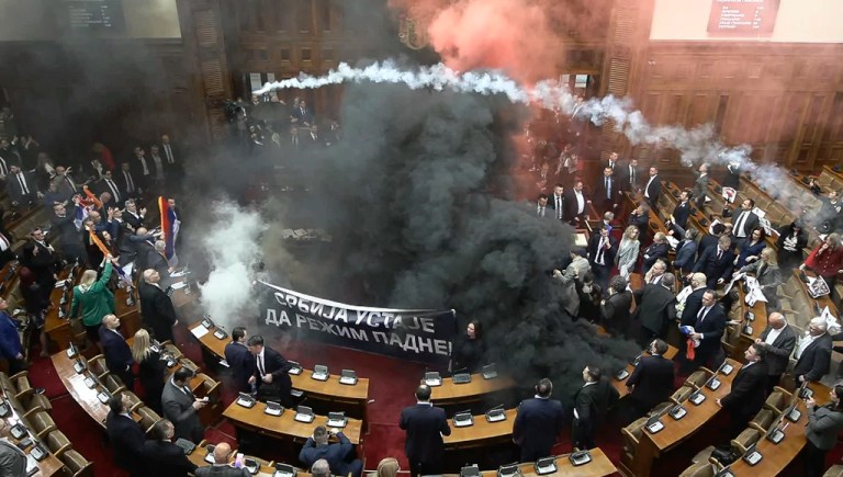 Serbian parliament devolves into chaos after opposition MPs throw smoke and stun grenades