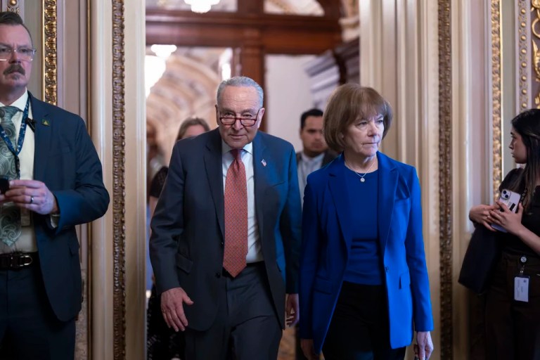Senate Minority Leader Chuck Schumer (D-NY), left, walks with Sen. Tina Smith (D-MN) as Senate Democrats gather behind closed doors to mount a last-ditch protest over a Republican-led spending bill that already passed the House, at the Capitol in Washington, Thursday, March 13, 2025.