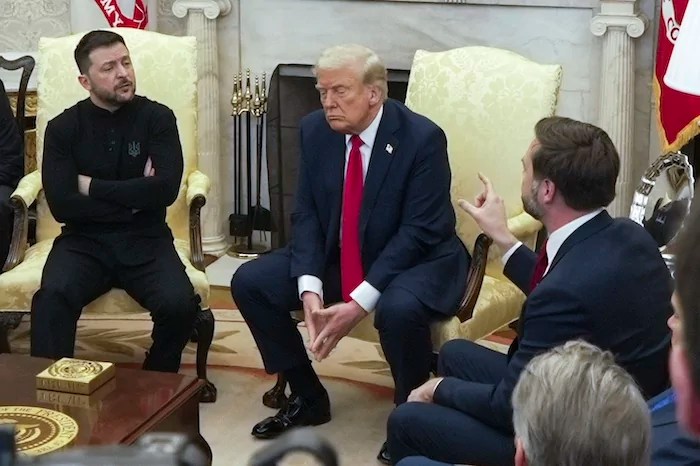 Vice President JD Vance, right, speaks with Ukrainian President Volodymyr Zelensky, left, as President Donald Trump listens in the Oval Office at the White House, Friday, Feb. 28, 2025, in Washington.