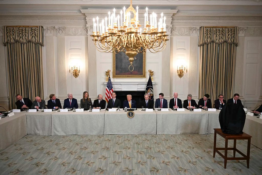 President Donald Trump, center, attends the White House Crypto Summit in Washington, Friday, March 7, 2025. (Pool via AP)