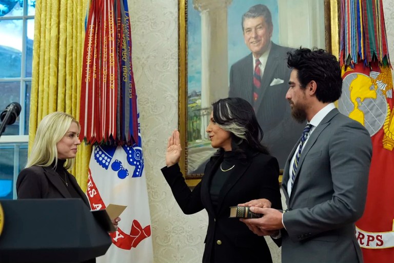 Attorney General Pam Bondi swears in Tulsi Gabbard as the director of national intelligence in the Oval Office of the White House, Wednesday, Feb. 12, 2025, in Washington, as her husband, Abraham Williams, holds the Bible.