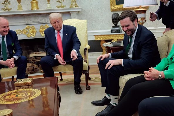U.S. President Donald Trump points to Vice President JD Vance's shamrock socks while hosting Irish Taoiseach Micheal Martin (L) at the White House on March 12, 2025 in Washington, DC. Martin is visiting the United States for the Irish leader's annual St. Patrick's Day visit where he met with U.S. President Donald Trump ahead of a St. Patrick's Day luncheon with Congressional leaders. (